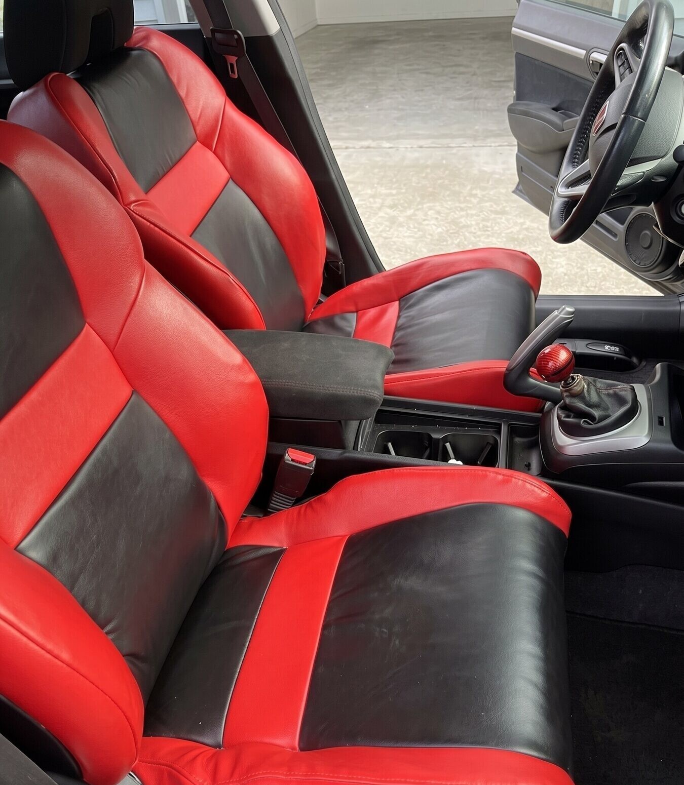 Pair of finished sport seats upholstered in red and black