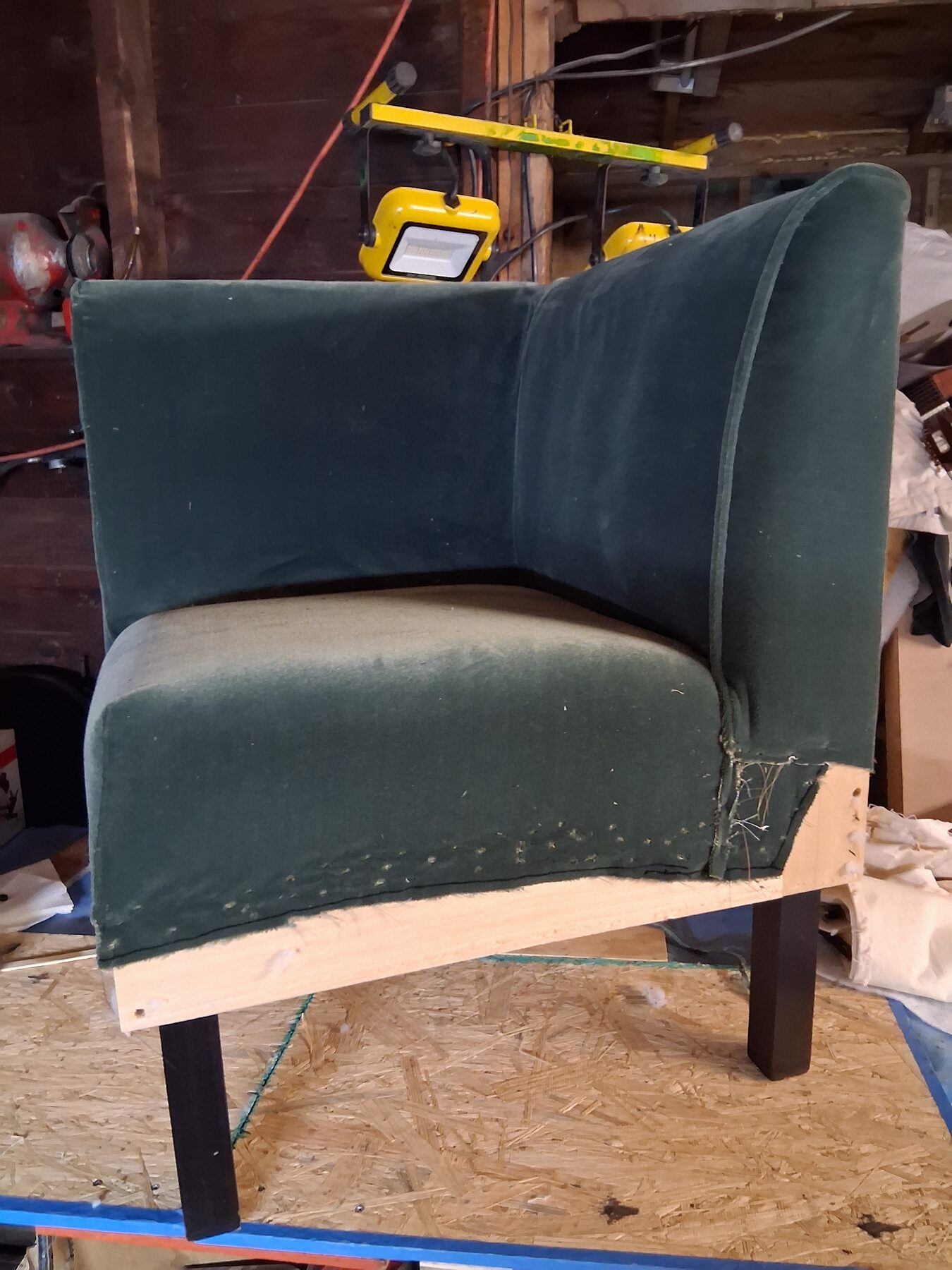 New green velvet mid-fit on the corner chair, base still exposed at the seam