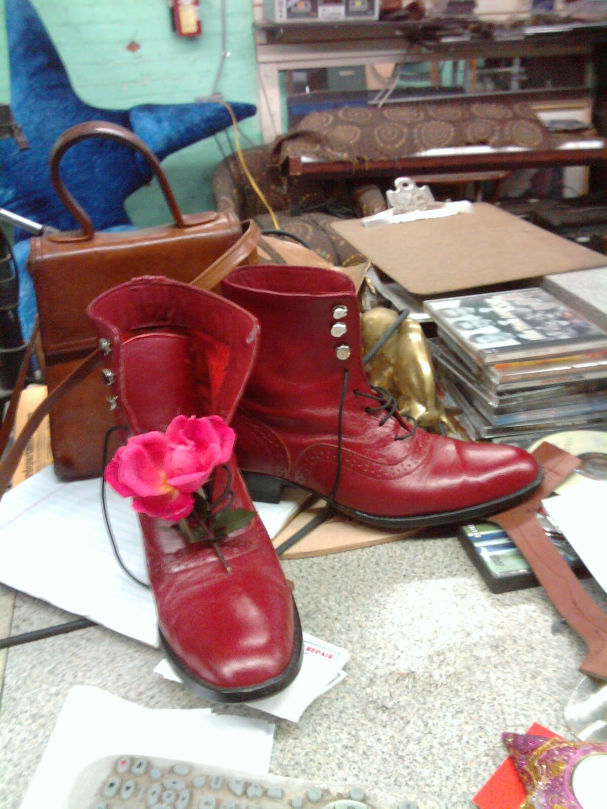 Pair of red leather lace-up ankle boots with brogued wingtips and studded side closures